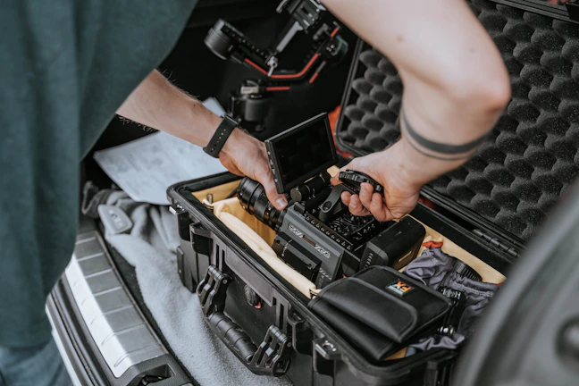 Technician installing a GPS tracker inside a cargo truck at a Táctico GPS facility