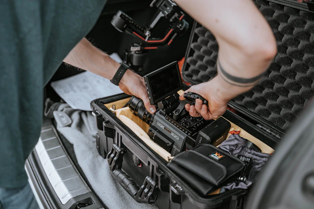 A professional technician installing a vehicle tracking device inside a car.
