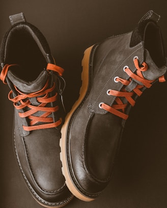 black and brown leather lace up boots