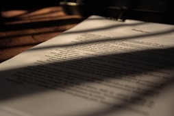 white book page on brown wooden table