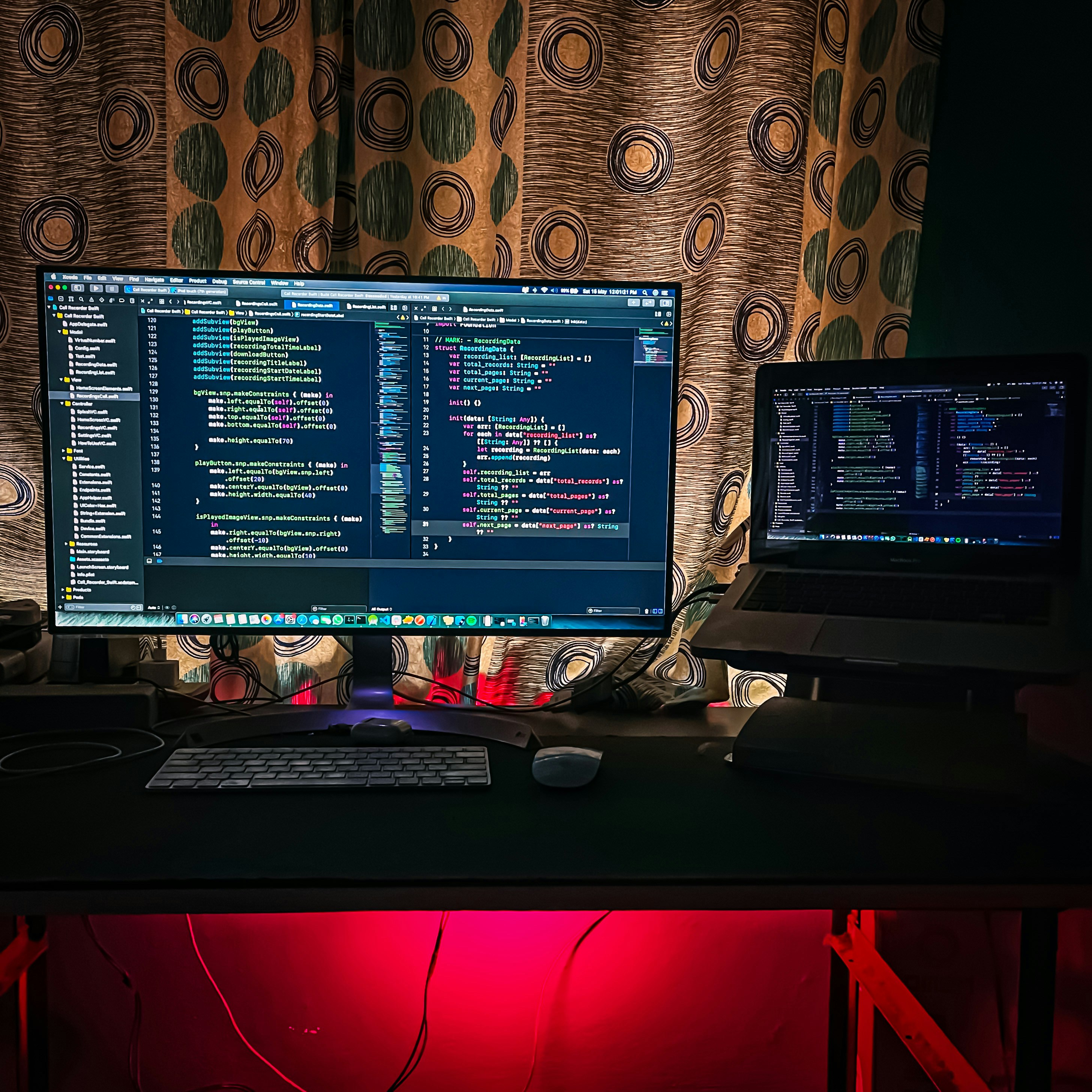 Developer intently coding in dark environment with multiple screens showing agent workflow