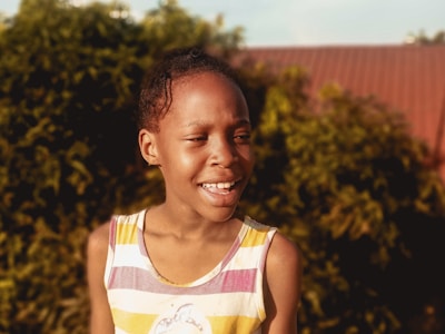 A mentor and a young person sharing a smile during an outdoor activity.