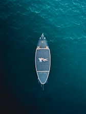 white and black boat on body of water