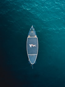 white and black boat on body of water