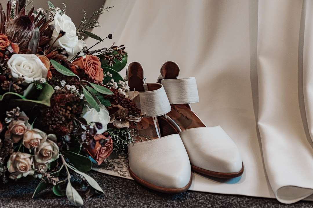 white leather peep toe heeled shoes beside green plant