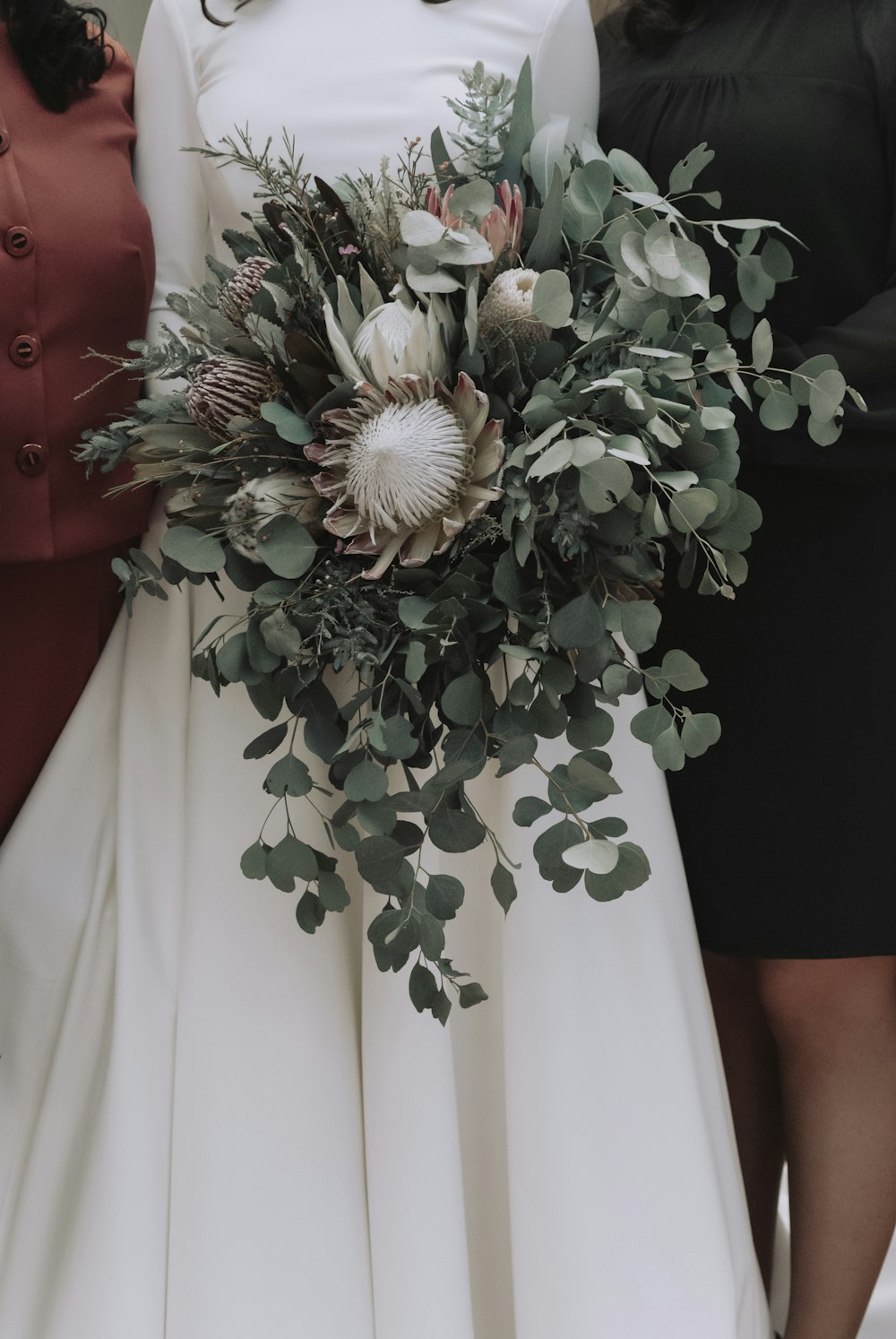 white flower bouquet on white textile