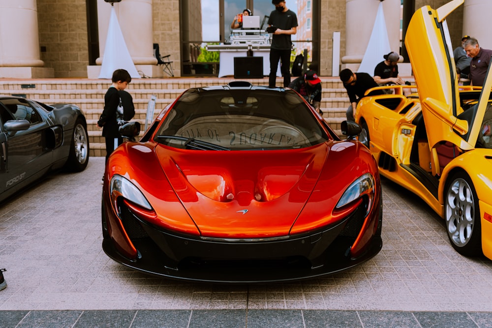 red ferrari 458 italia parked near people walking on street during daytime