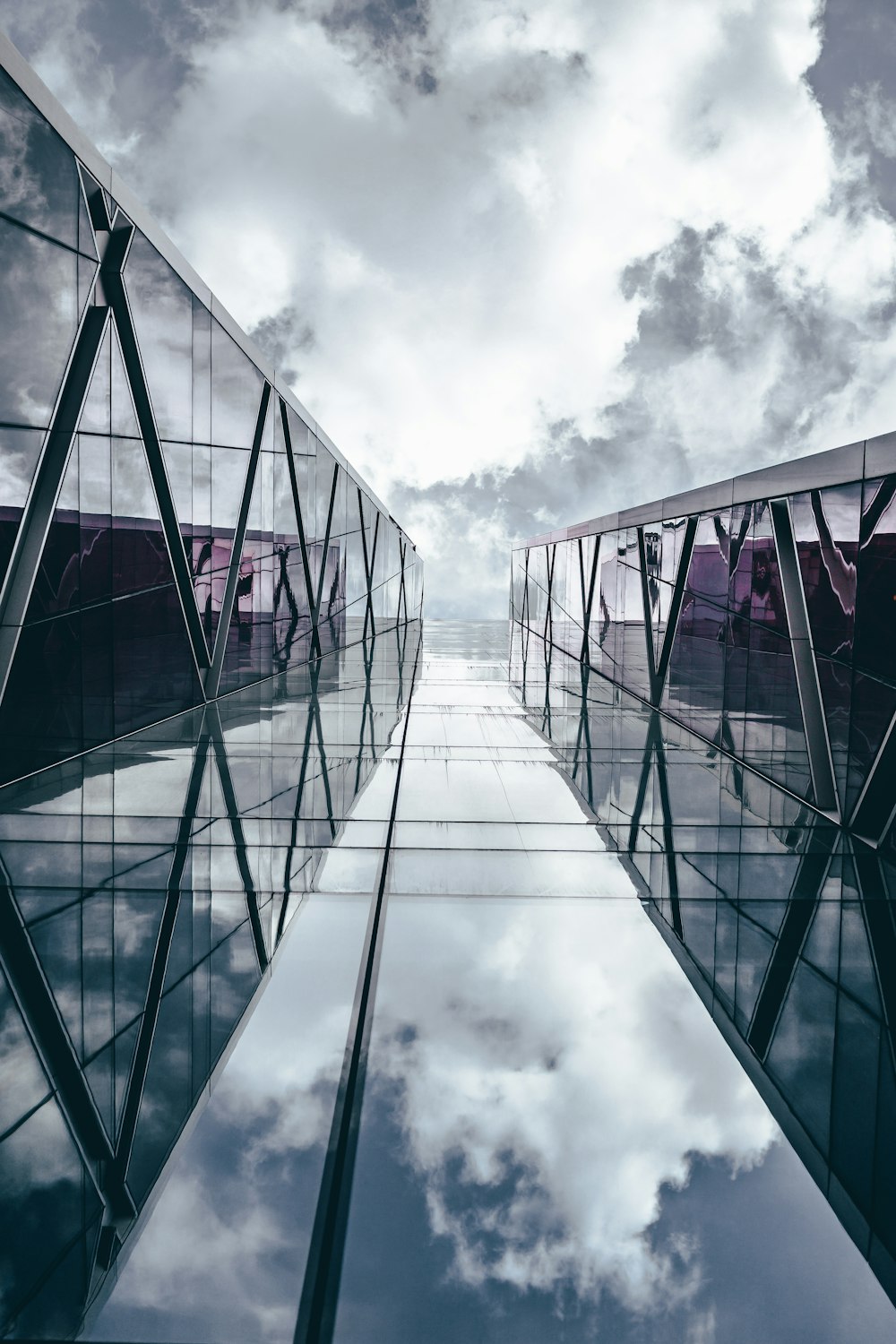 low angle photography of high rise building under cloudy sky