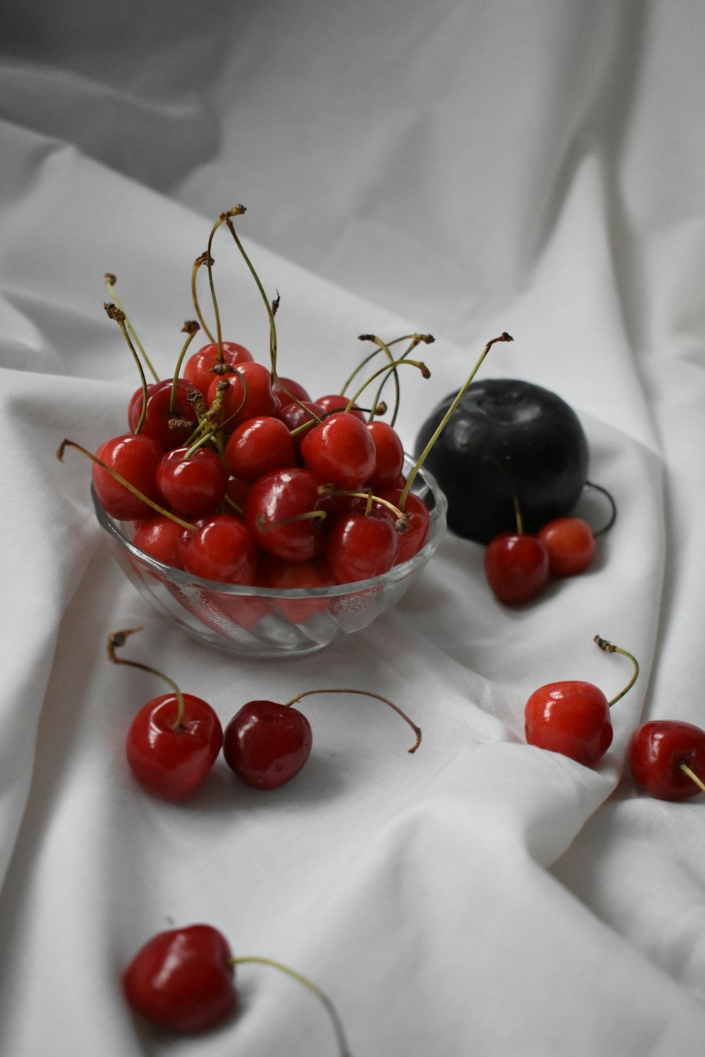 red cherries in clear glass bowl
