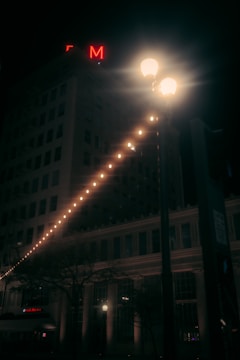 Close-up of illuminated signage on a commercial building at night.