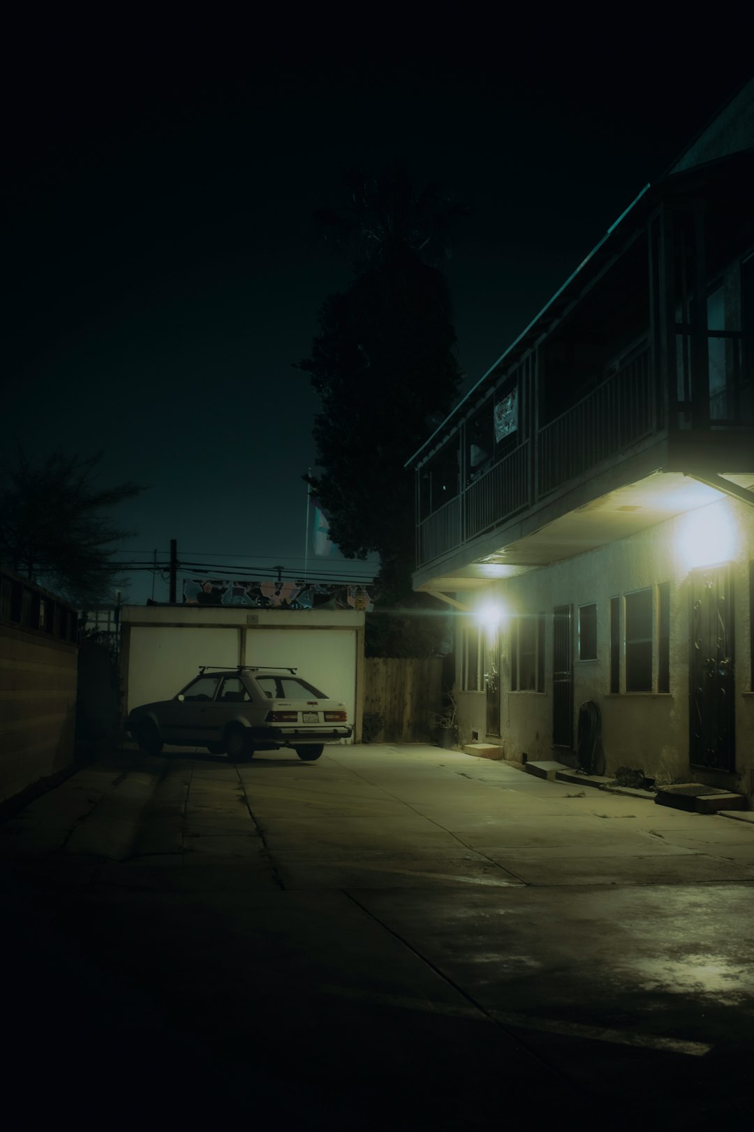 white car parked beside building during night time