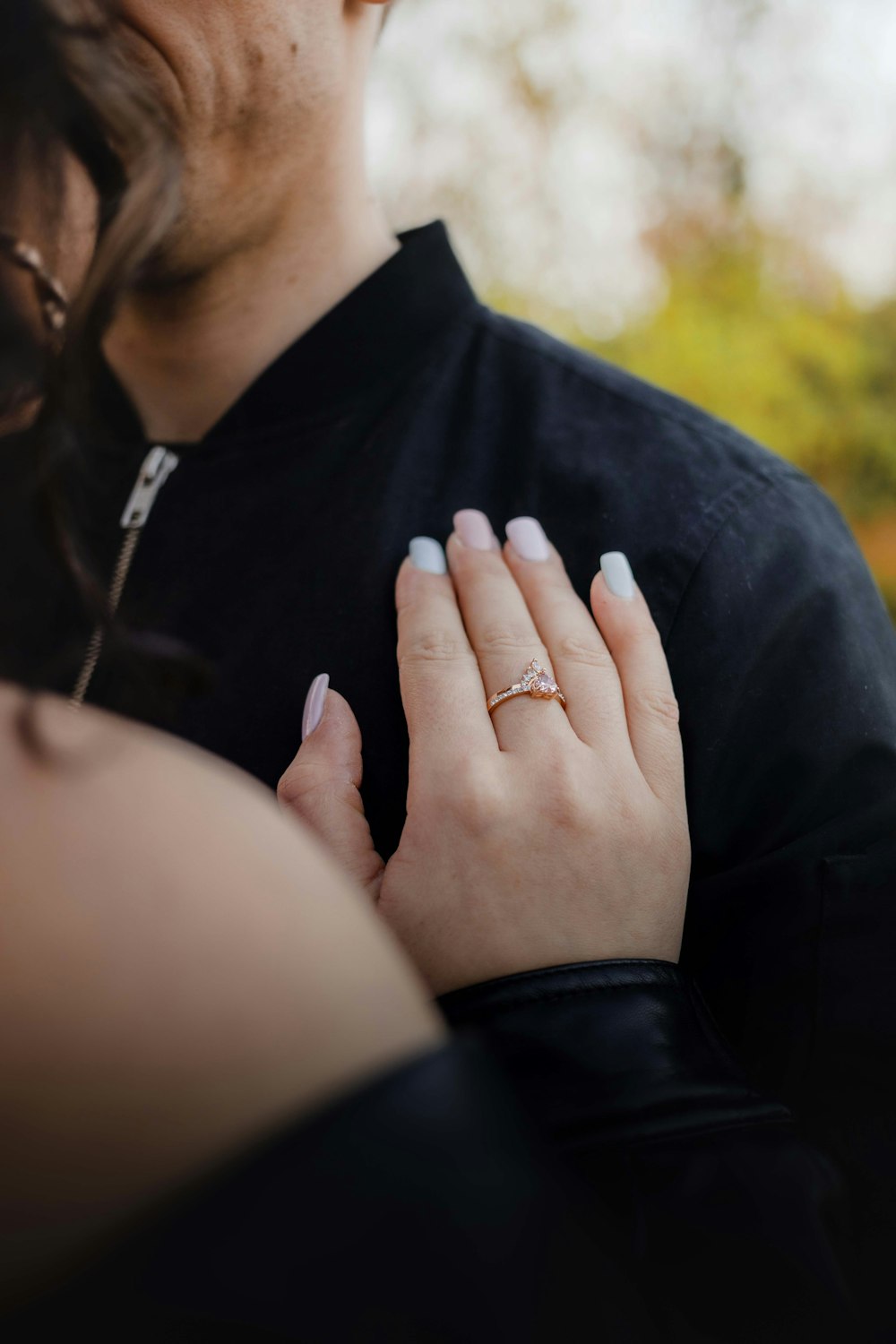 man in black button up shirt holding womans hand