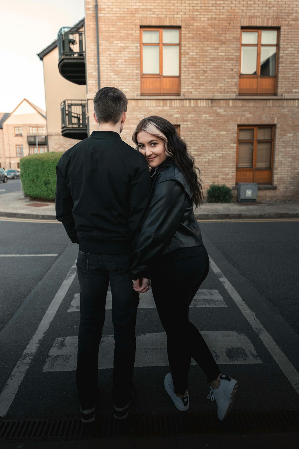 man in black coat standing beside woman in black coat