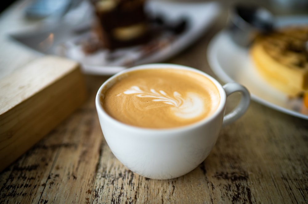 white ceramic cup with brown liquid