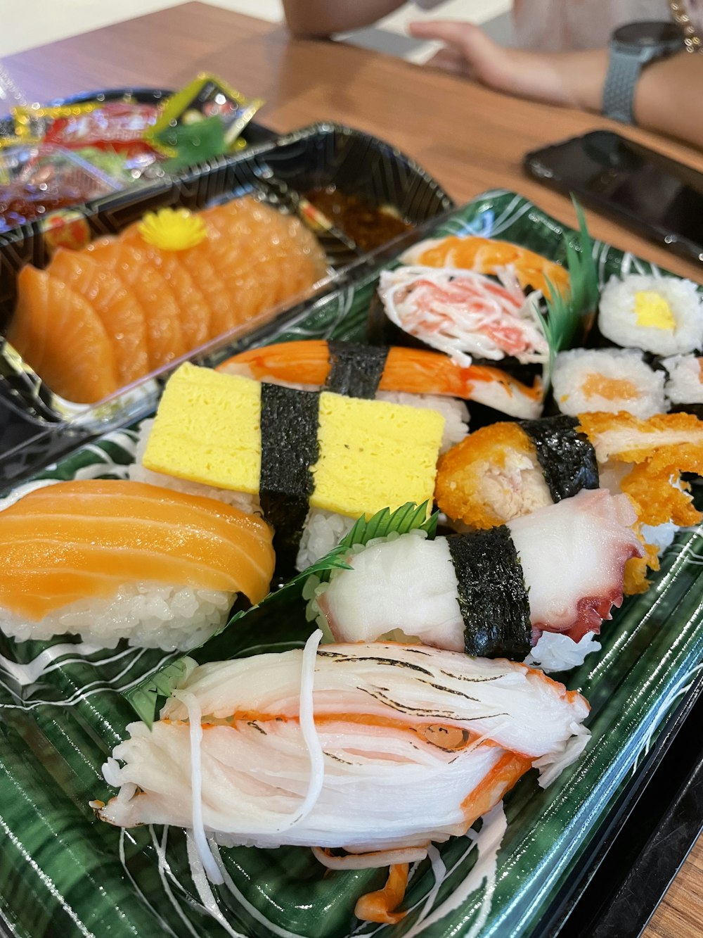 sushi on black plastic tray