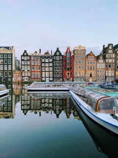 boat on water near buildings during daytime