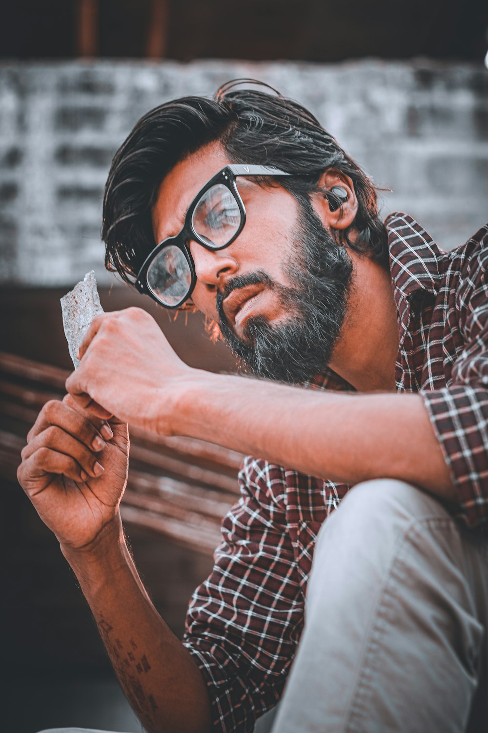 man in black and white checkered button up shirt wearing black framed eyeglasses