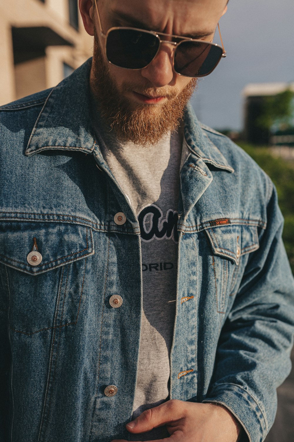 man in blue denim button up jacket