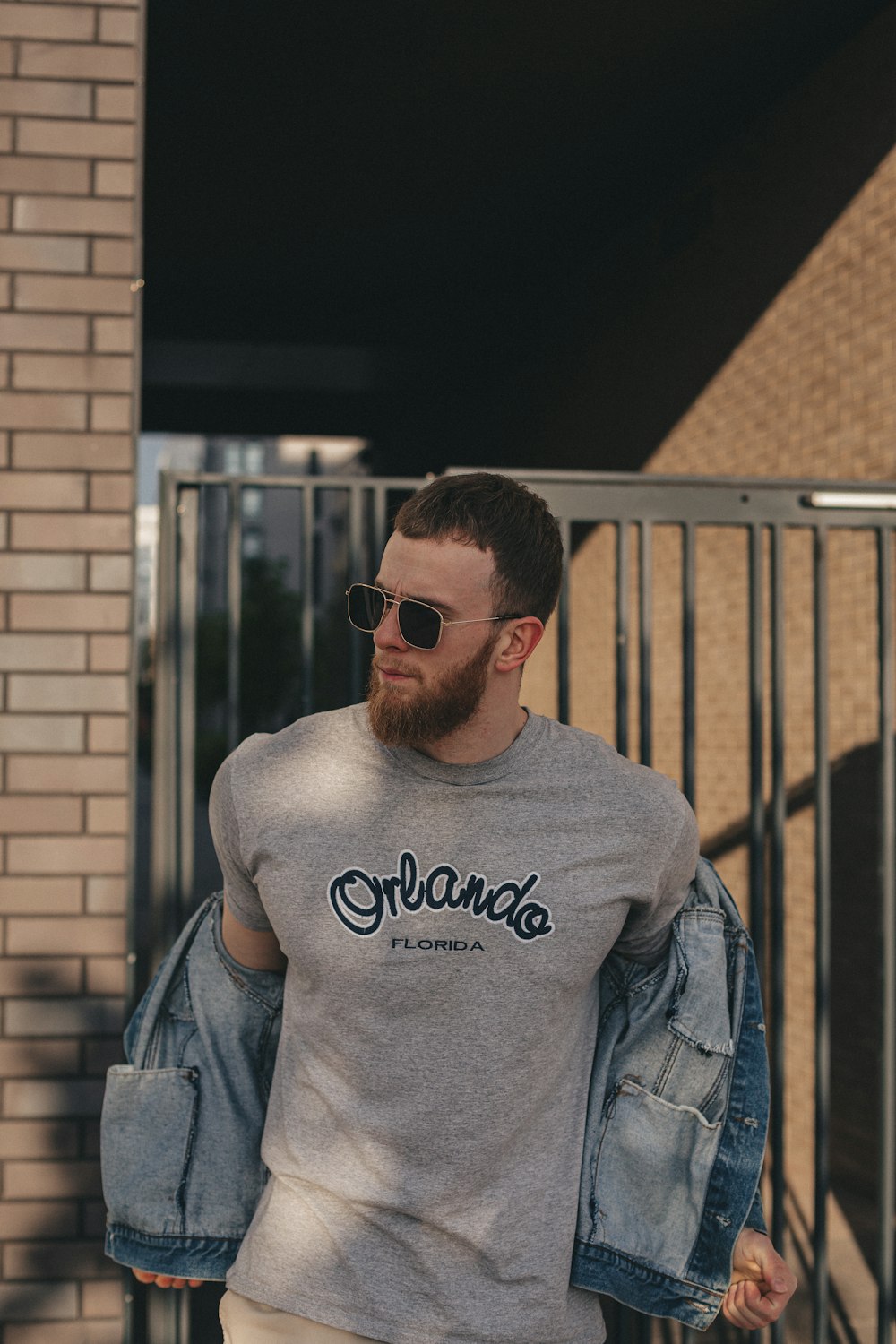 man in gray crew neck shirt wearing black sunglasses