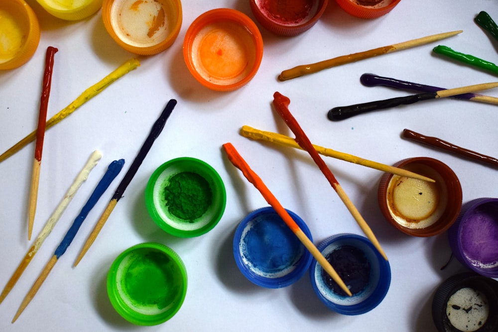 assorted color paint brush on white table