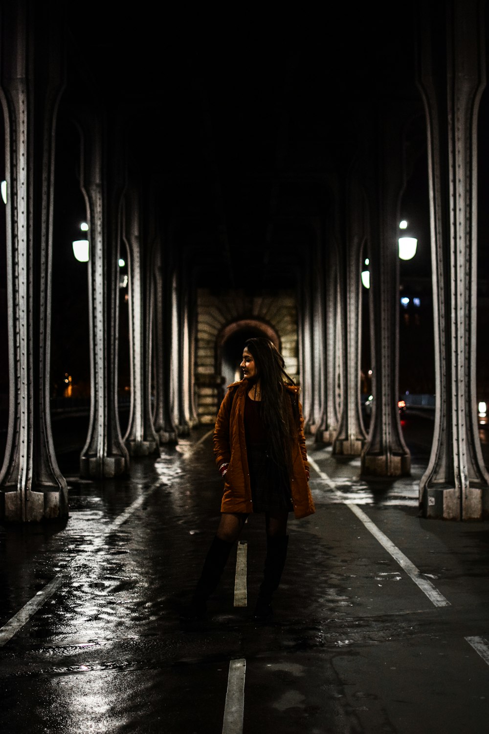 woman in brown coat walking on hallway