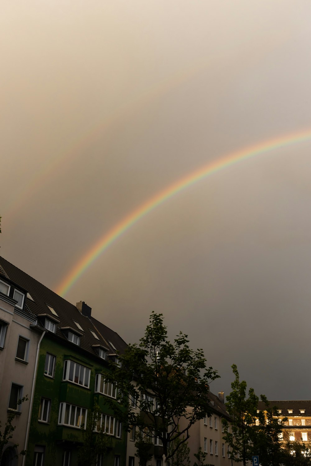 rainbow over white and black concrete building