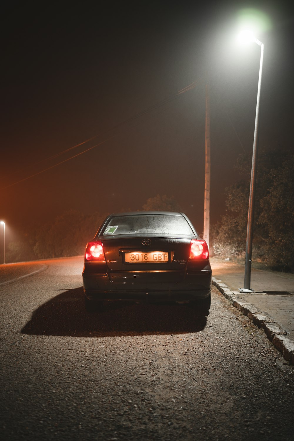 red car on road during night time