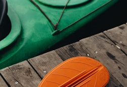 green and orange wooden boat