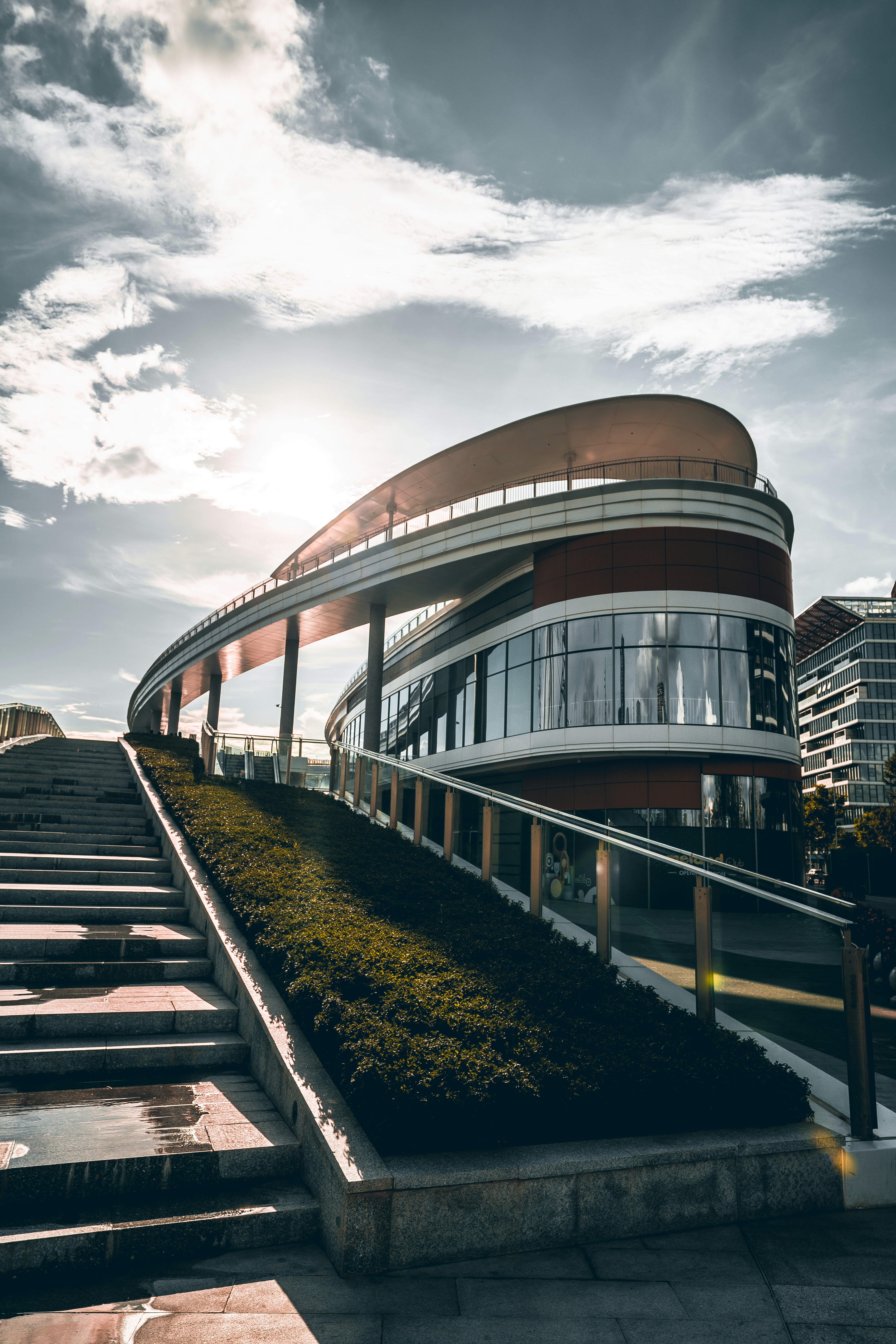 brown and white concrete building under white clouds during daytime