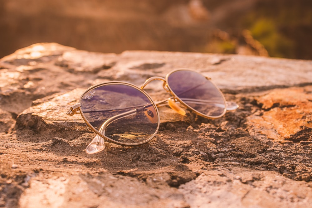 silver framed aviator style sunglasses on brown sand