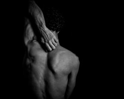 man holding neck suffering from chronic pain 