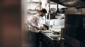 A chef preparing fresh ingredients in our kitchen.