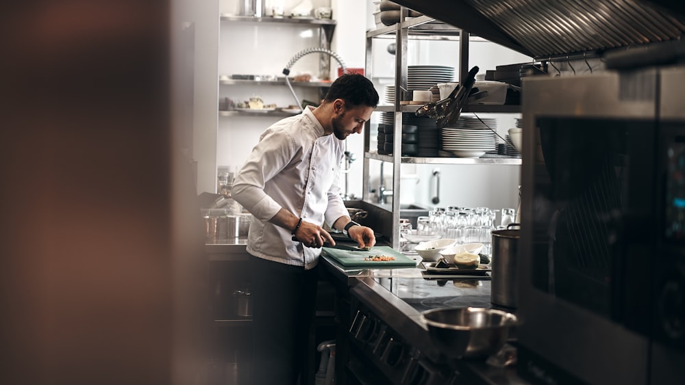 man in white dress shirt holding white ceramic plate