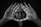 A person looks through a triangle formed by their hands, creating a focused and intense gaze. The image is in black and white, enhancing the dramatic and introspective mood.