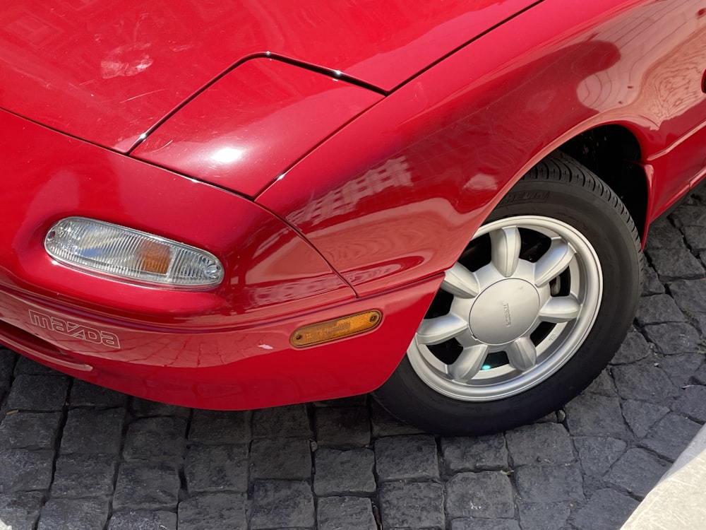 red car with white 5 spoke wheel