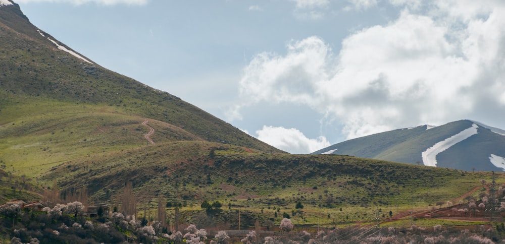 green and brown mountain under white clouds during daytime