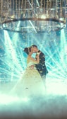 woman in white wedding dress holding blue string lights