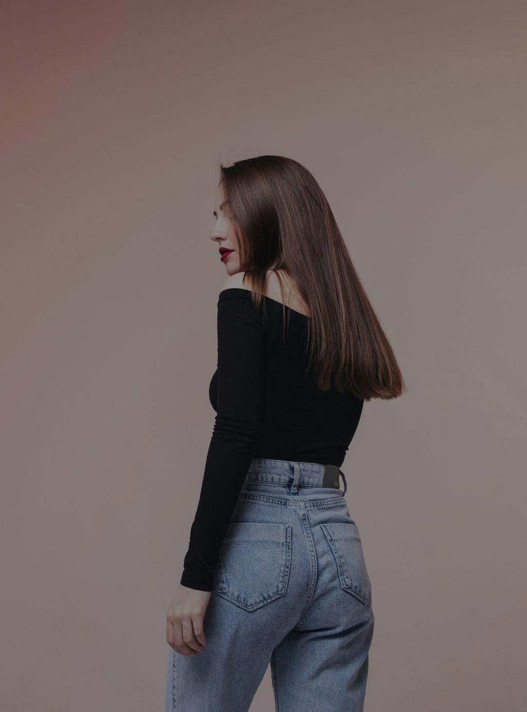 woman in black long sleeve shirt and blue denim jeans