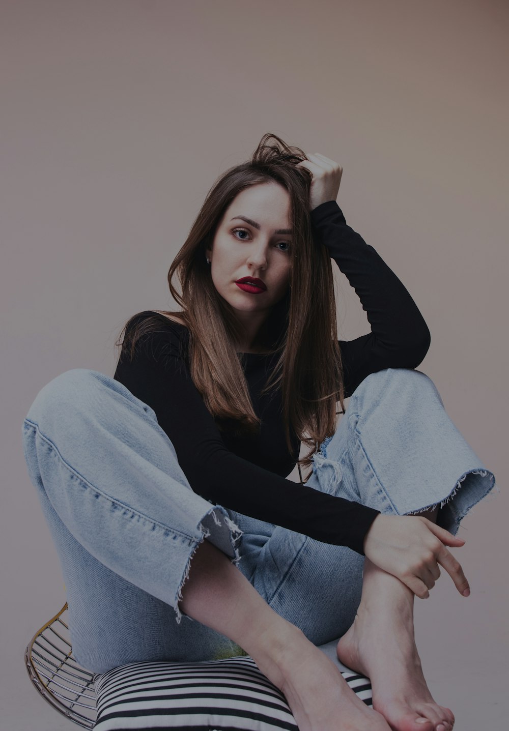 woman in blue denim jacket and blue denim jeans sitting on black chair