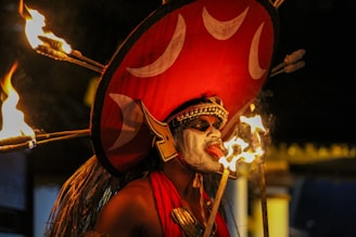 man in red and gold costume holding a stick