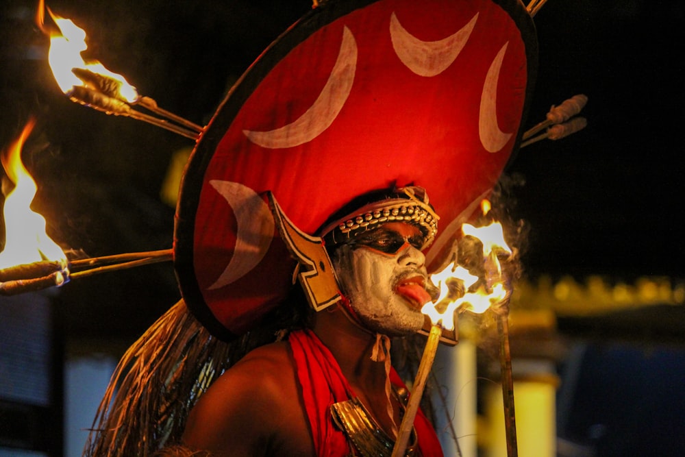 man in red and gold costume holding a stick