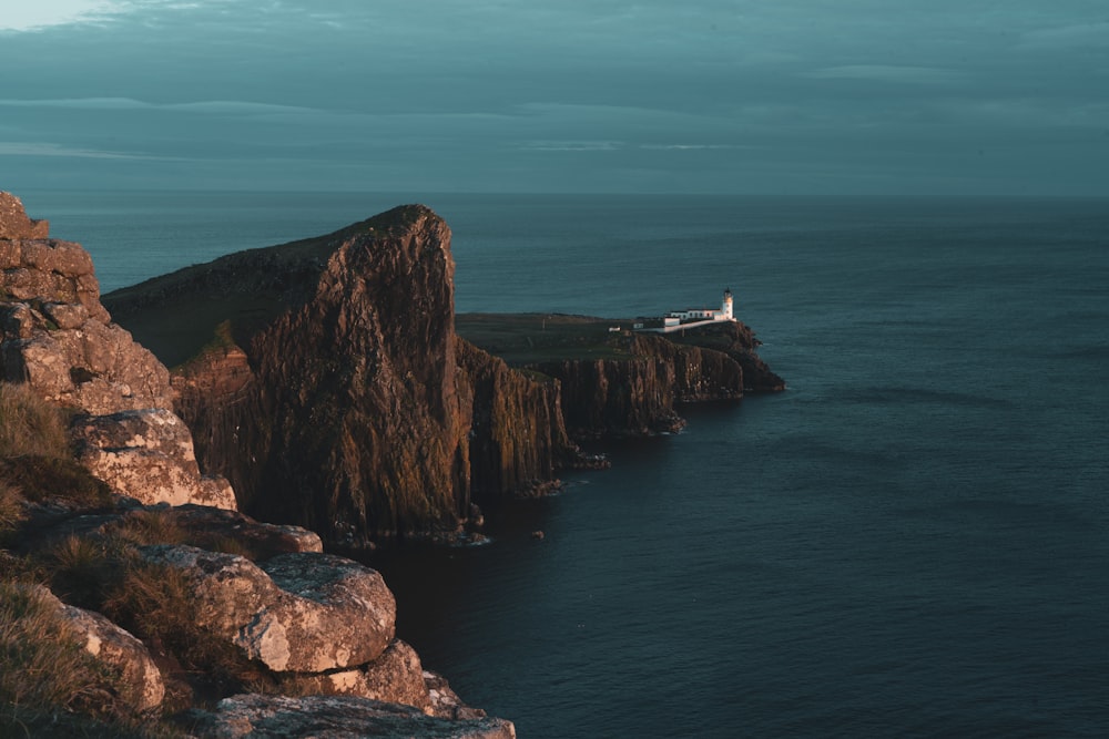 brown rock formation beside sea during daytime