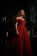A striking model in a flowing red gown, embodying elegance and confidence.