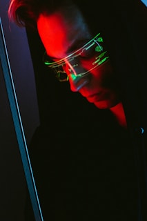 man in black framed eyeglasses looking at the window