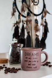 pink ceramic mug on table quote "Dreams are only dreams until you wake up and make them real"