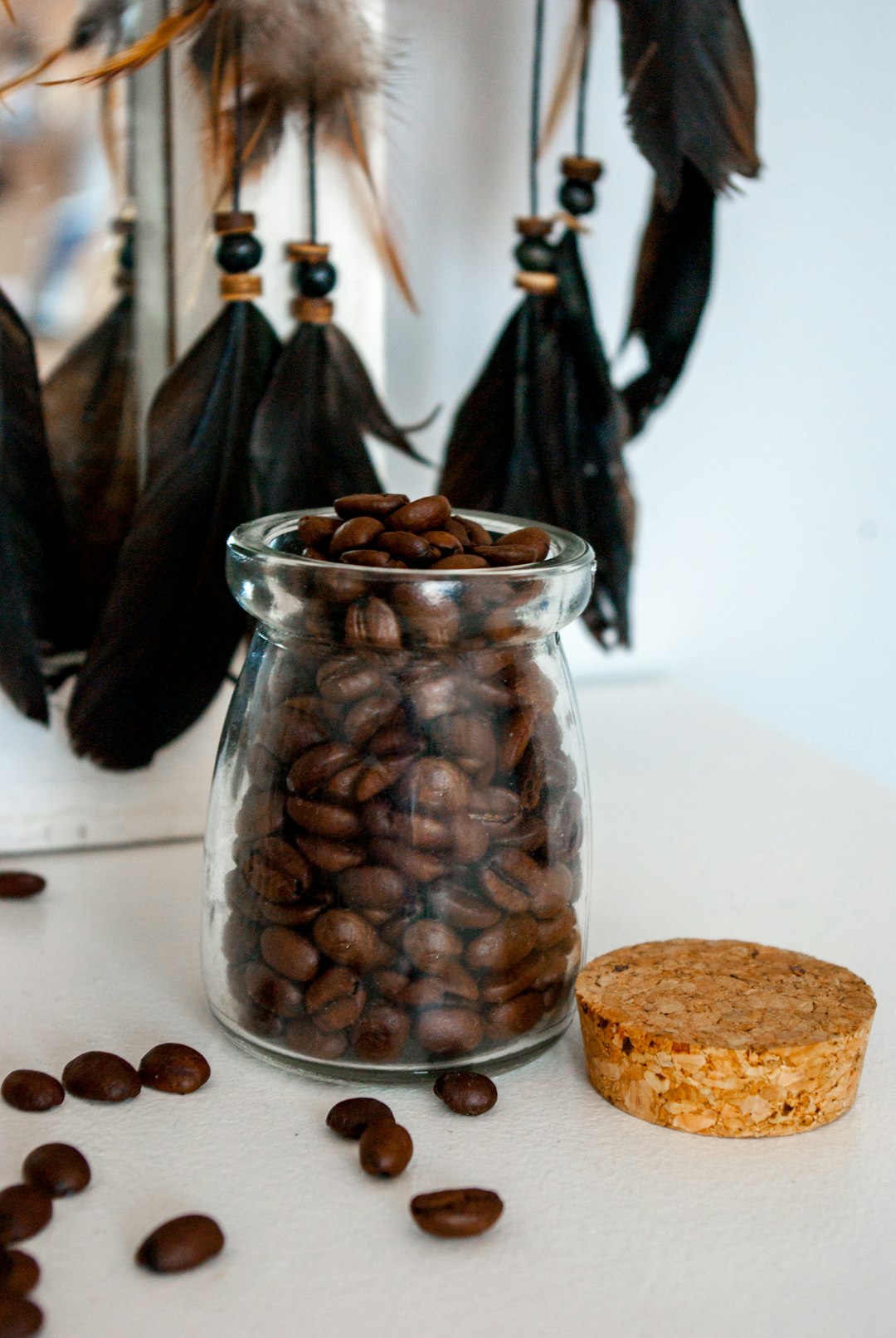 brown coffee beans in clear glass jar