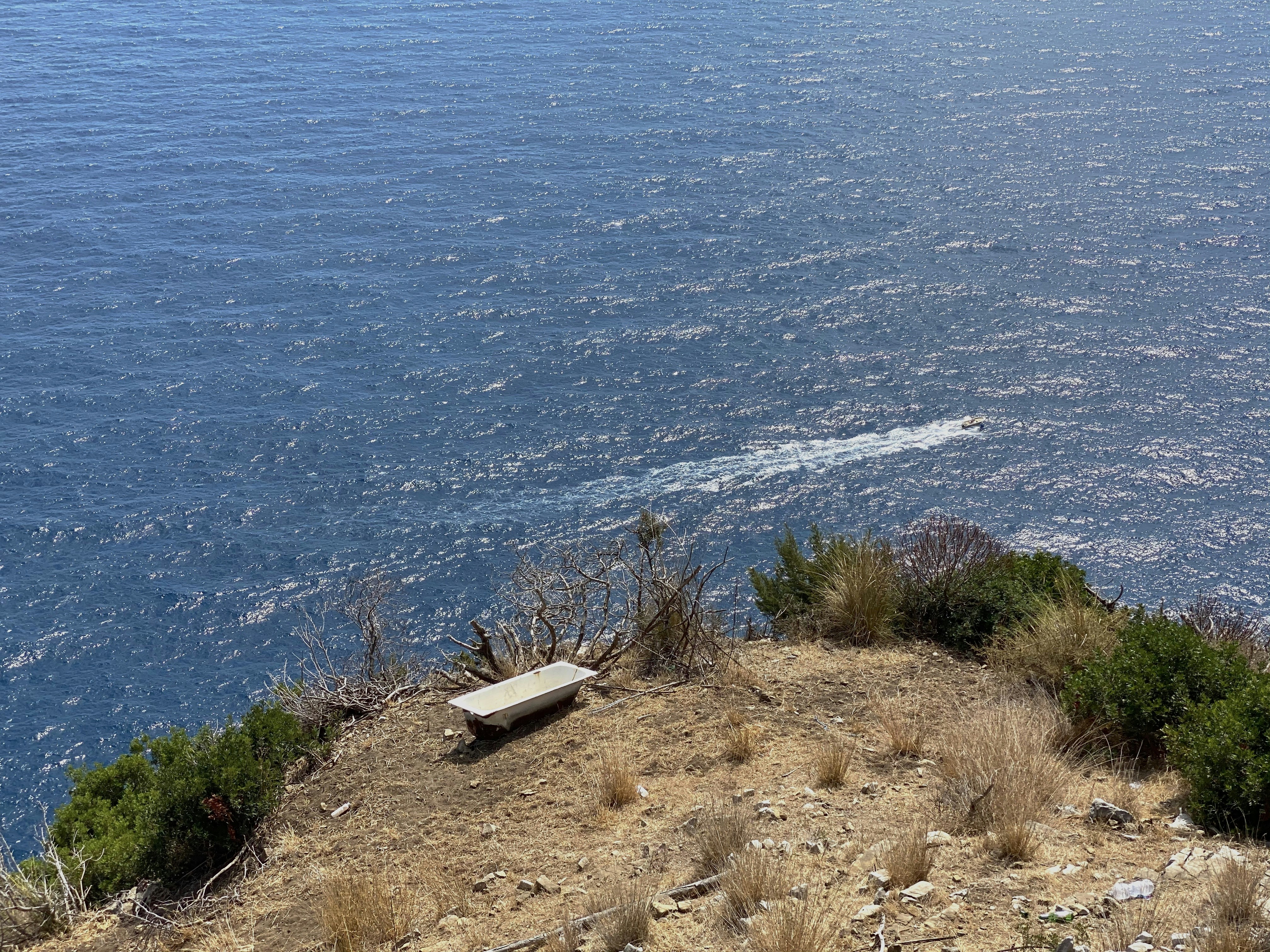 white car on brown sand near body of water during daytime
