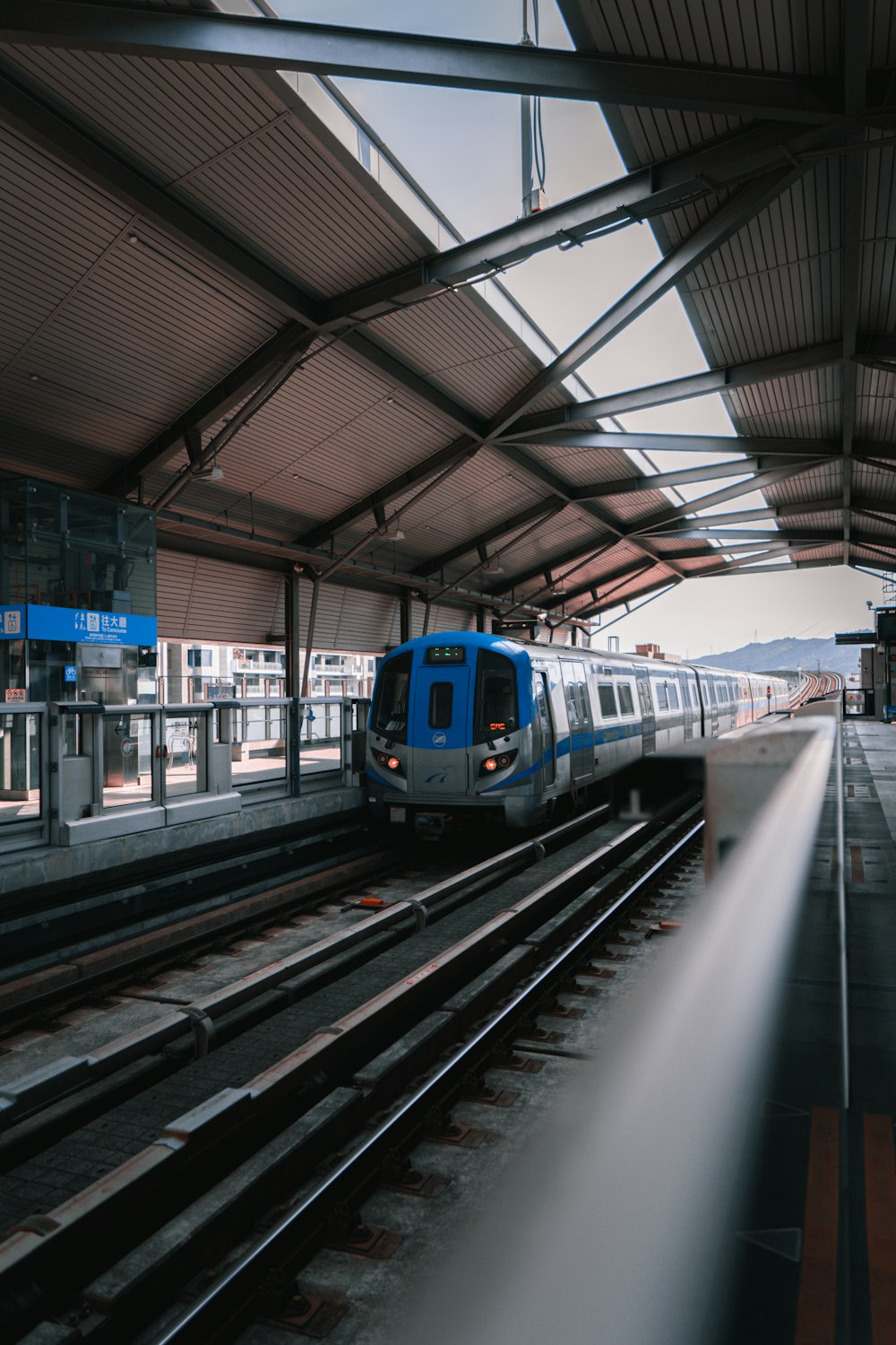 blue and white train on train station during daytime