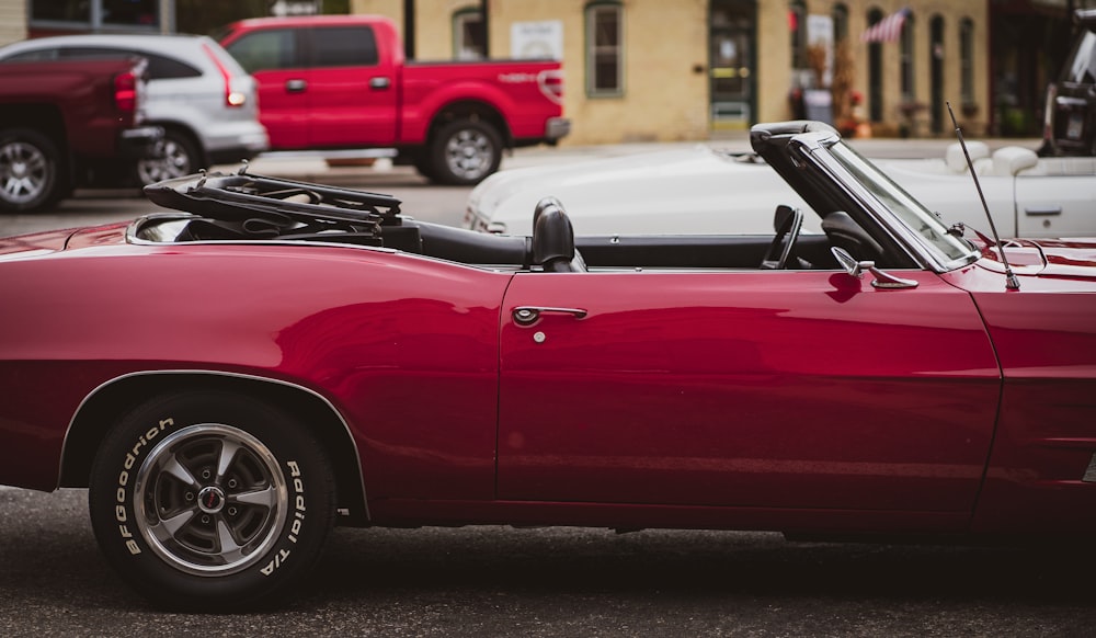 red convertible car on road during daytime