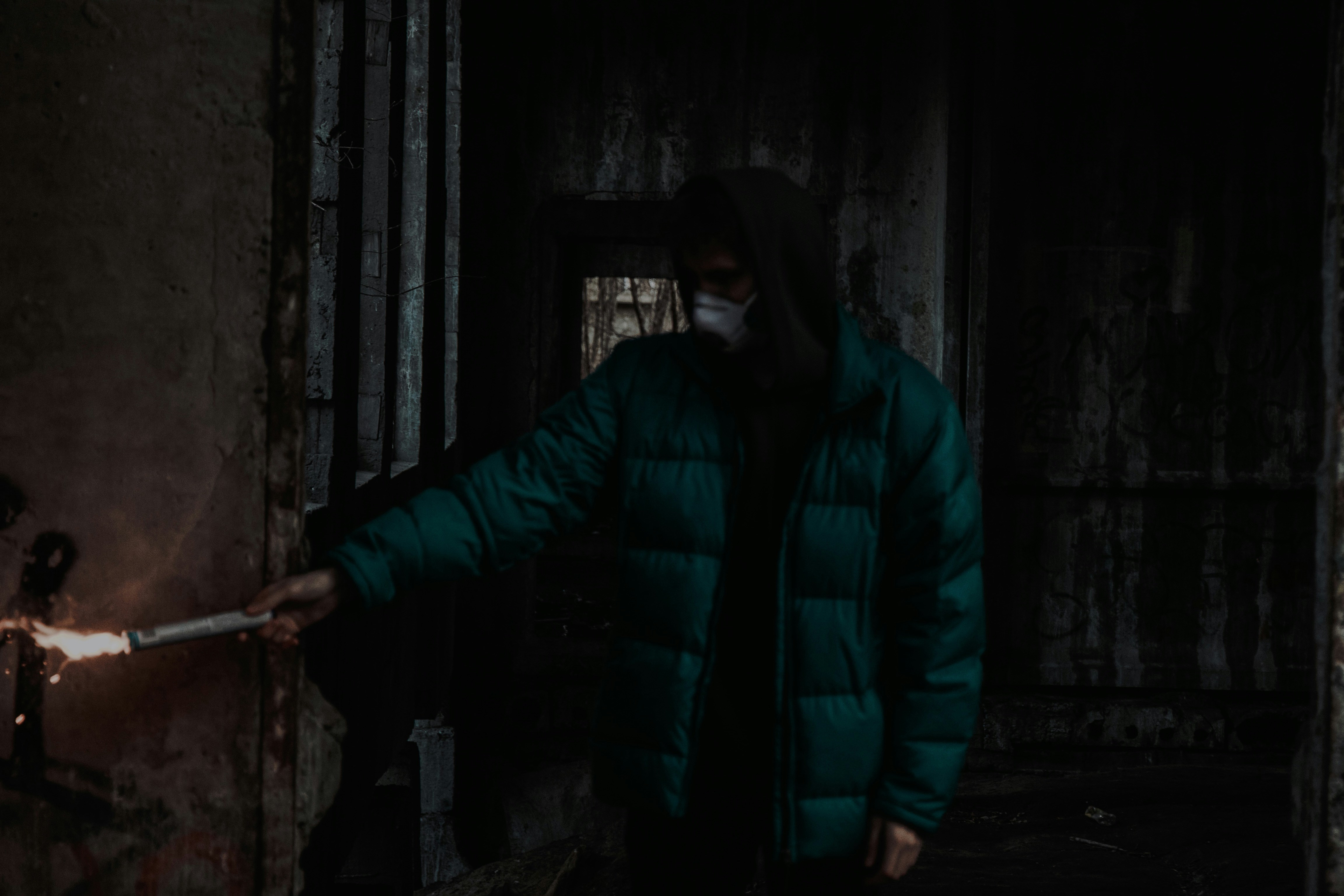 man in blue bubble jacket standing near door